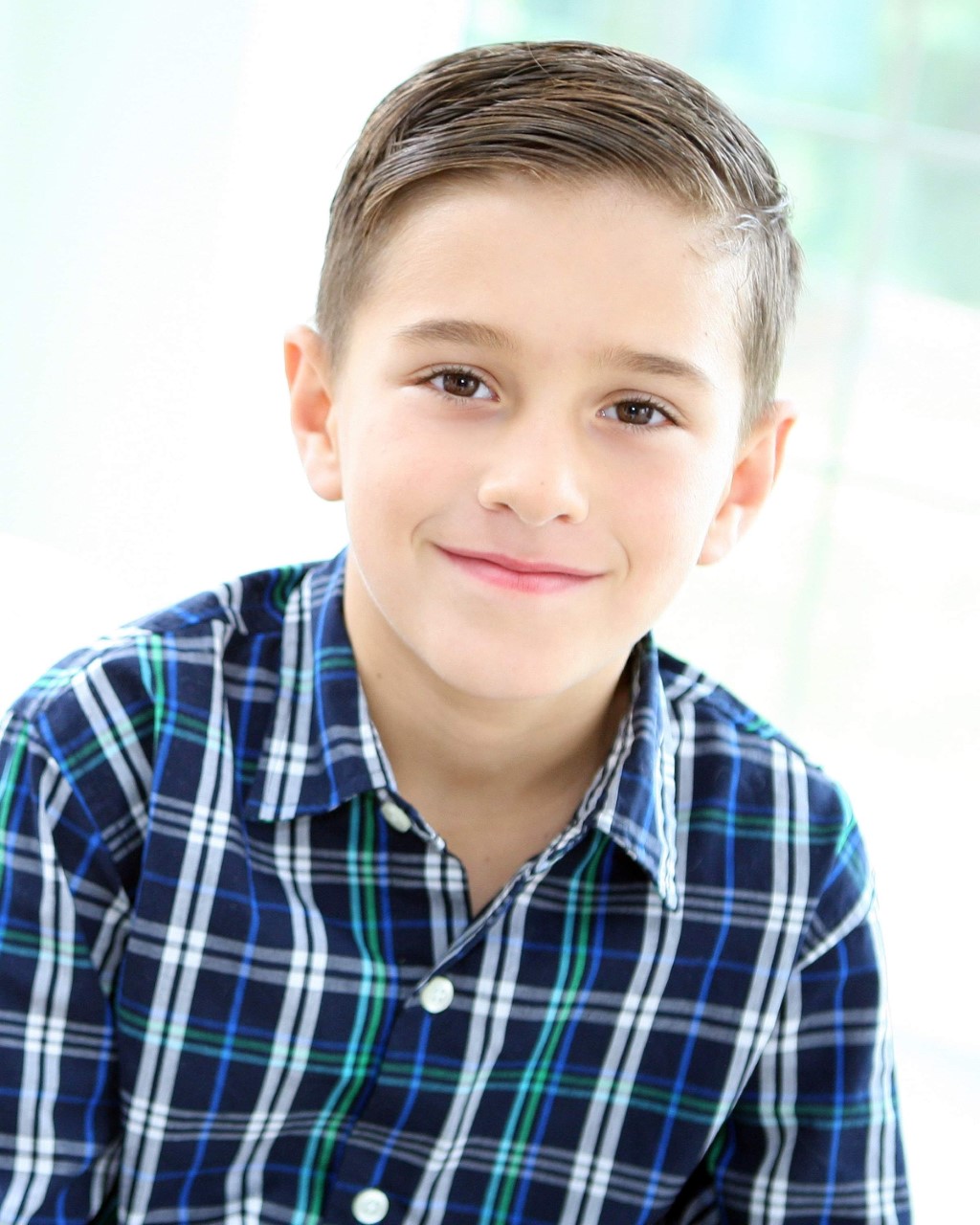 A Photo of Luca Calanni, wearing a blue flannel button-up shirt.